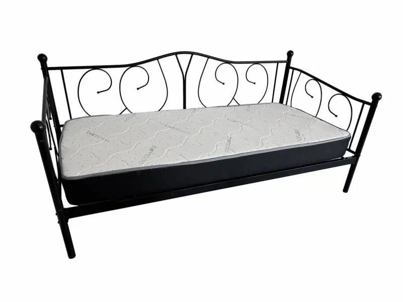 Black metal daybed with scrollwork design and white mattress