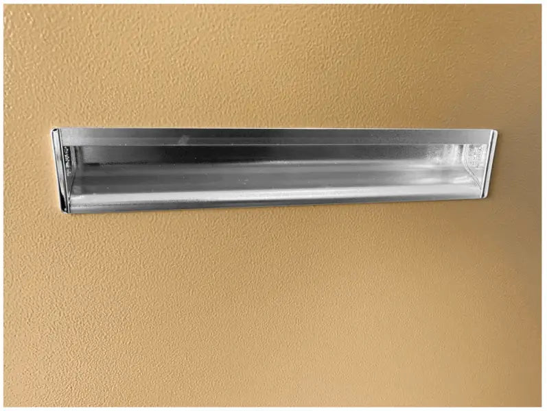 Rectangular fluorescent light fixture mounted on a wall.