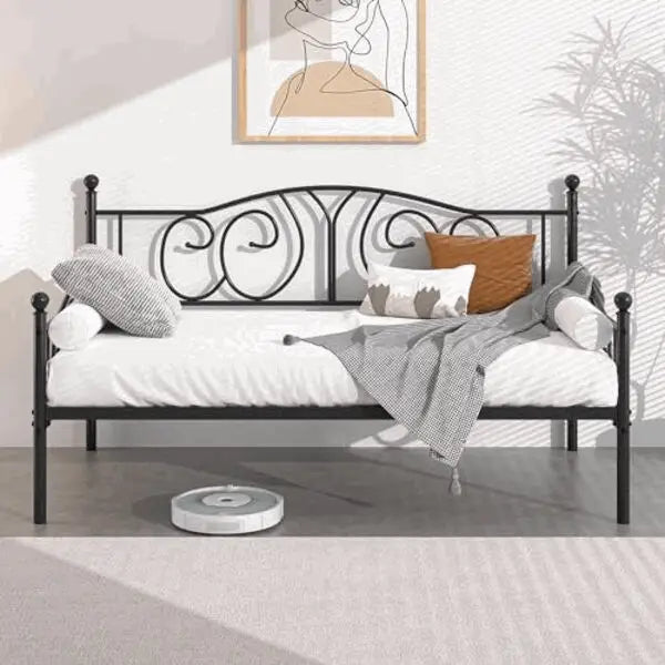 Metal daybed with scrolled headboard and white bedding
