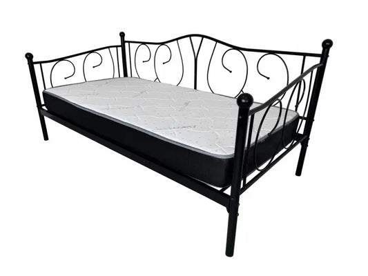 Black metal daybed with decorative scrollwork and a white mattress
